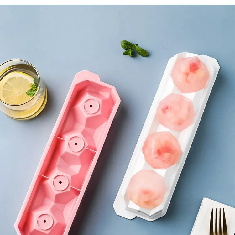 Silicone ice tray showing large hockey artefact and geometric round and pentagon ice cube moulds in assorted colours.
