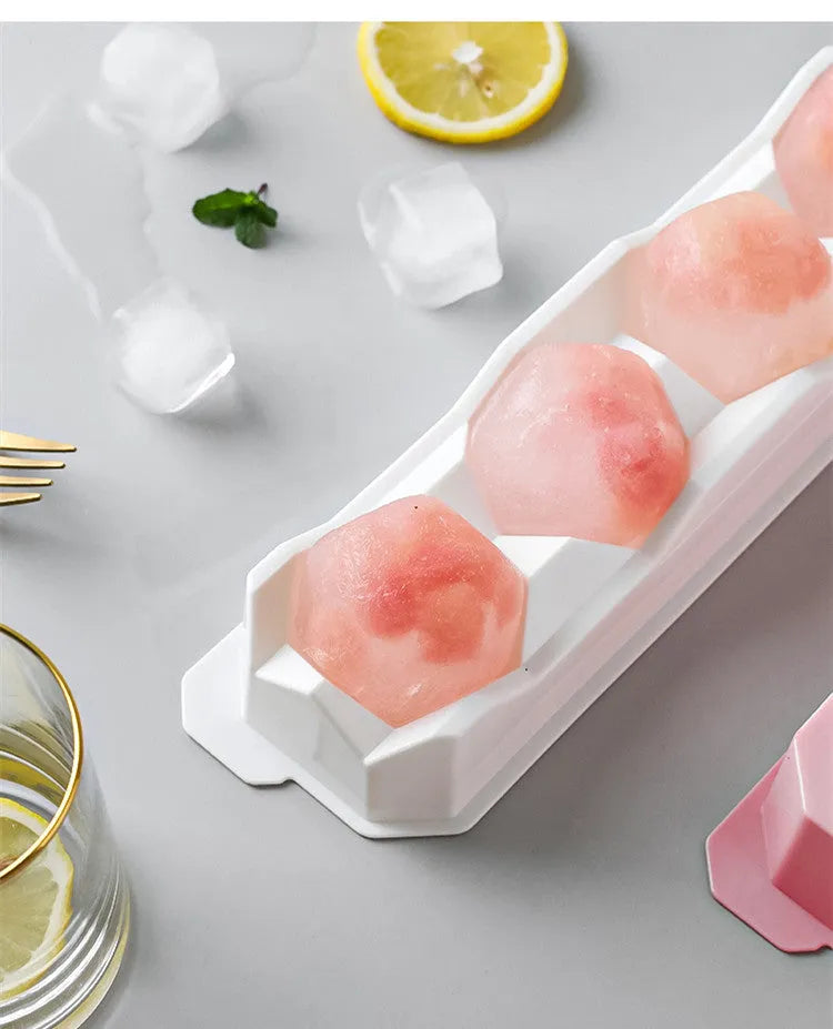Silicone ice tray showing large hockey artefact and geometric round and pentagon ice cube moulds in assorted colours.