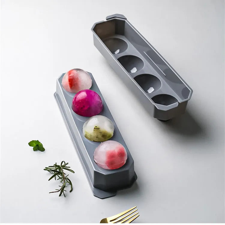 Silicone ice tray showing large hockey artefact and geometric round and pentagon ice cube moulds in assorted colours.