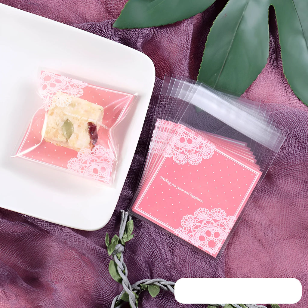 Pink self-adhesive plastic bag for packaging handmade soap bars on a table.