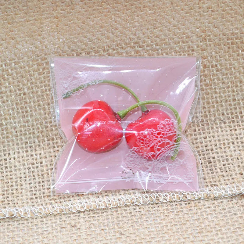 Pink self-adhesive plastic bag for packaging handmade soap bars on a table.