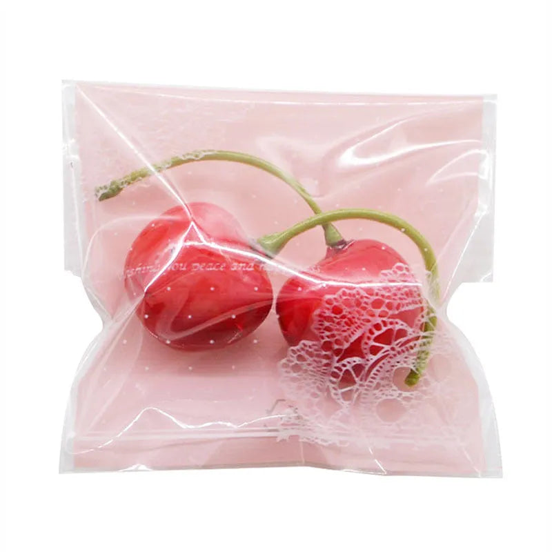Pink self-adhesive plastic bag for packaging handmade soap bars on a table.