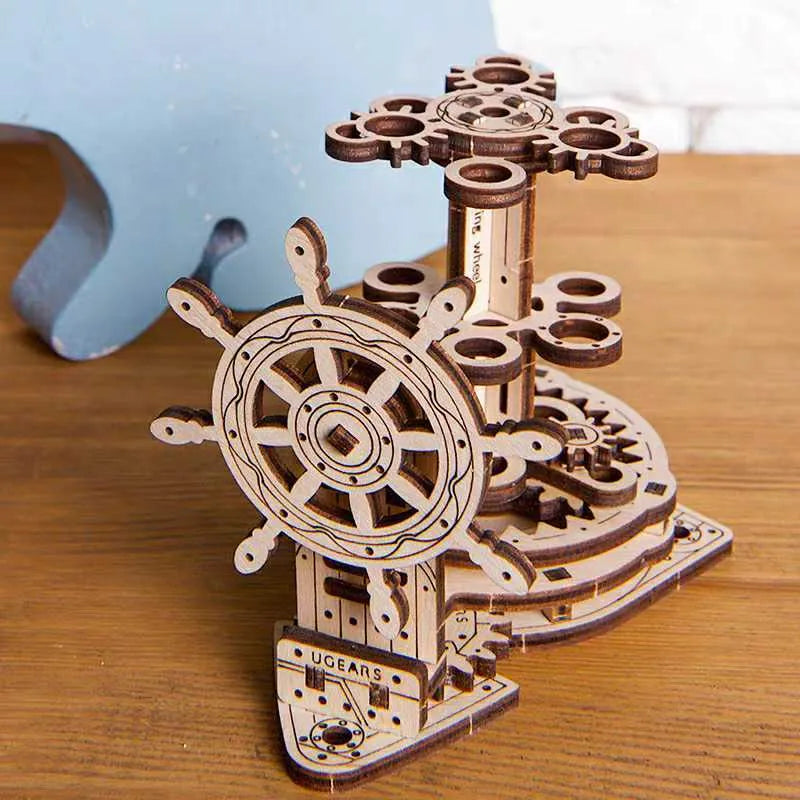 Assembled wooden desk pen holder with a steering wheel that rotates a central platform holding coloured pens.