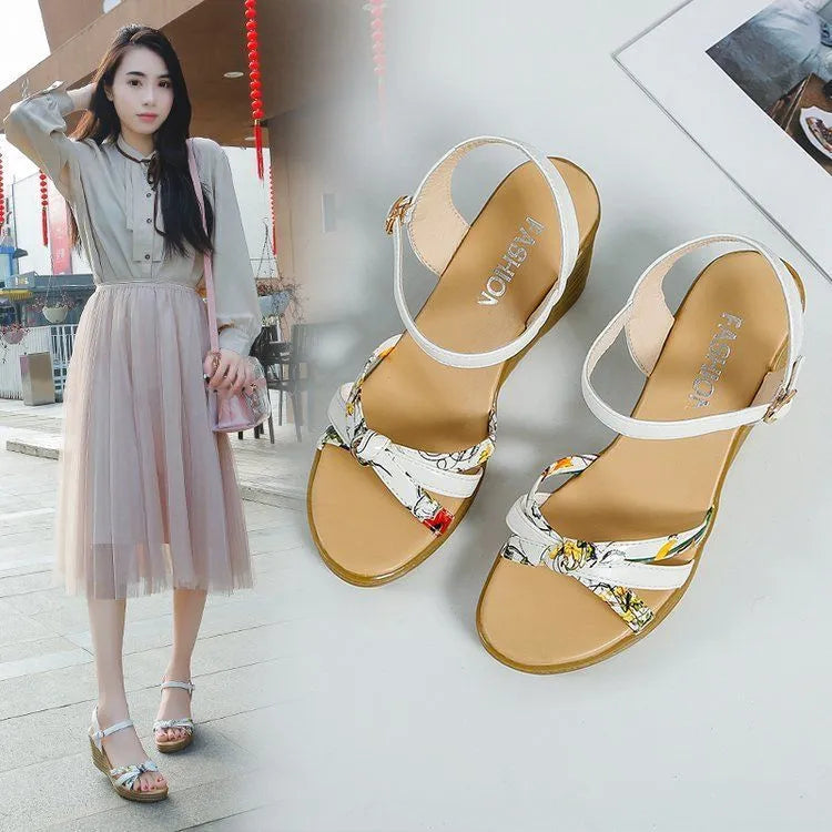 Pink women's wedge sandals with peep-toe, thick heel, and a single buckle fastening on a white background.