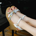 Pink women's wedge sandals with peep-toe, thick heel, and a single buckle fastening on a white background.