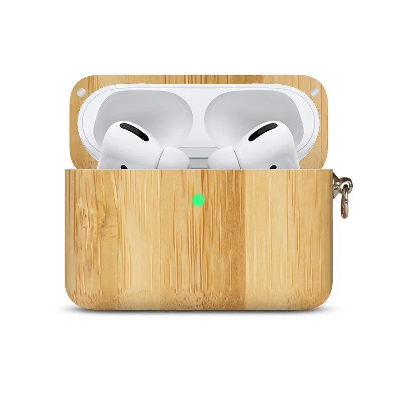 Solid wood earphone sleeve in walnut next to compatible wireless earphones on a wooden table.