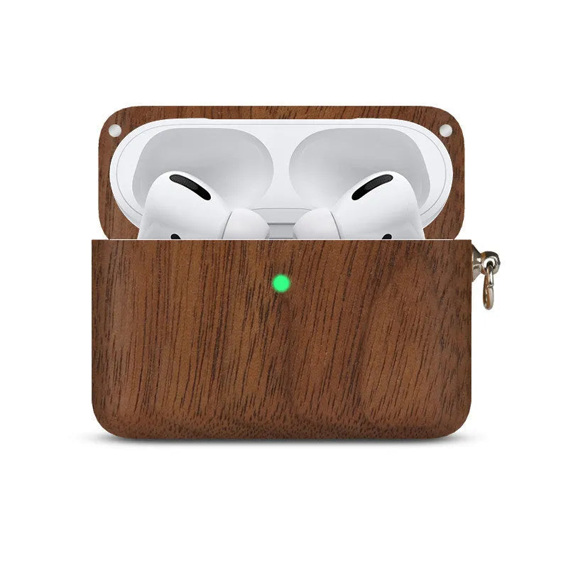 Solid wood earphone sleeve in walnut next to compatible wireless earphones on a wooden table.