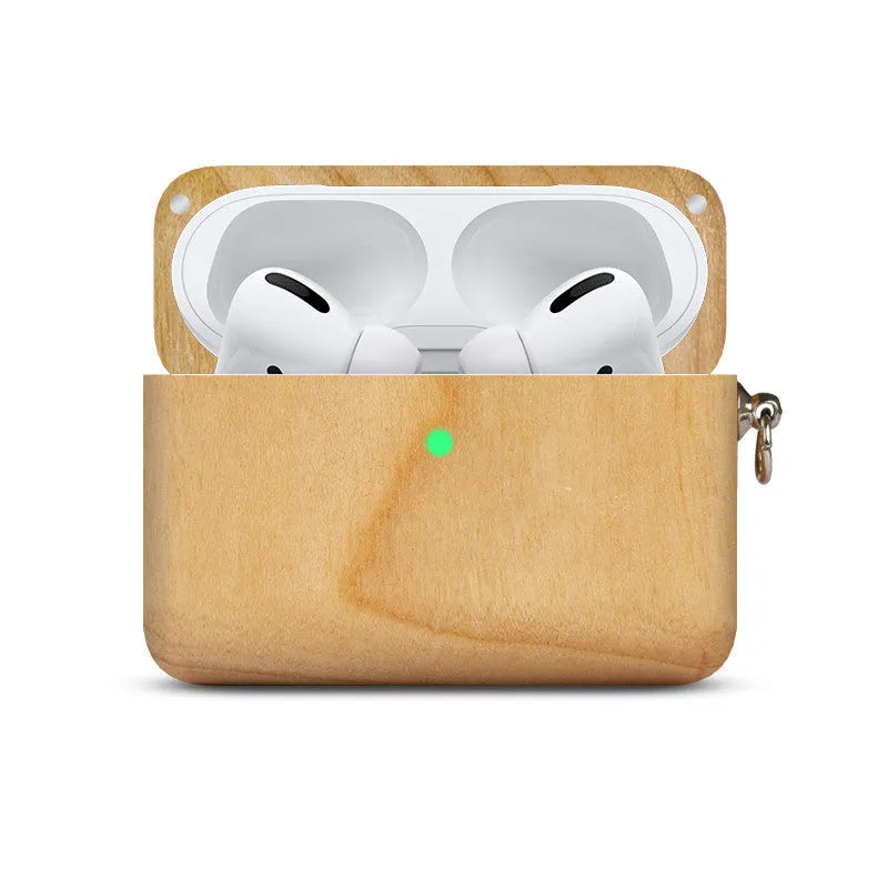 Solid wood earphone sleeve in walnut next to compatible wireless earphones on a wooden table.