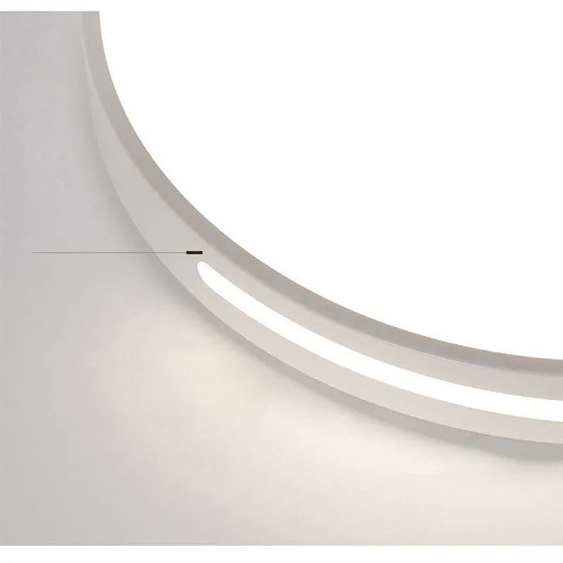 Round modern acrylic LED ceiling lamp with remote control on a white ceiling.