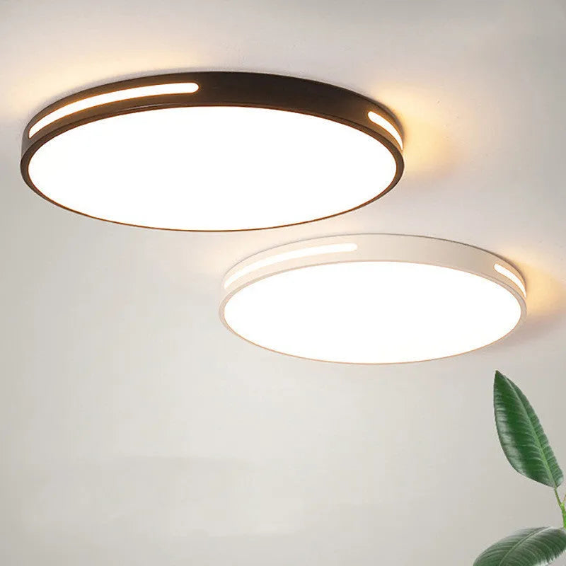 Round modern acrylic LED ceiling lamp with remote control on a white ceiling.