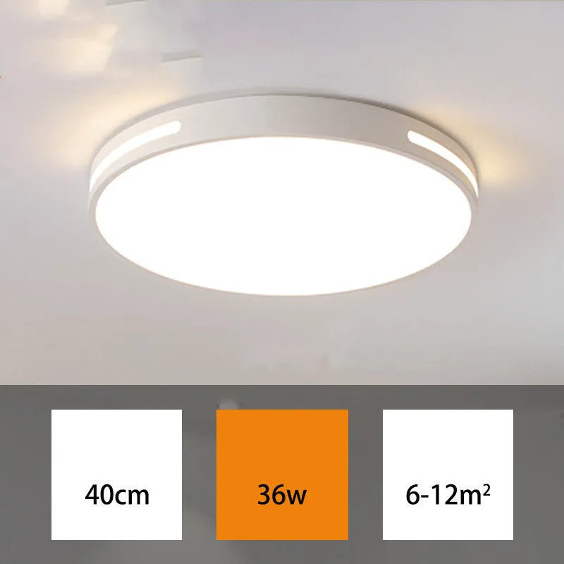 Round modern acrylic LED ceiling lamp with remote control on a white ceiling.