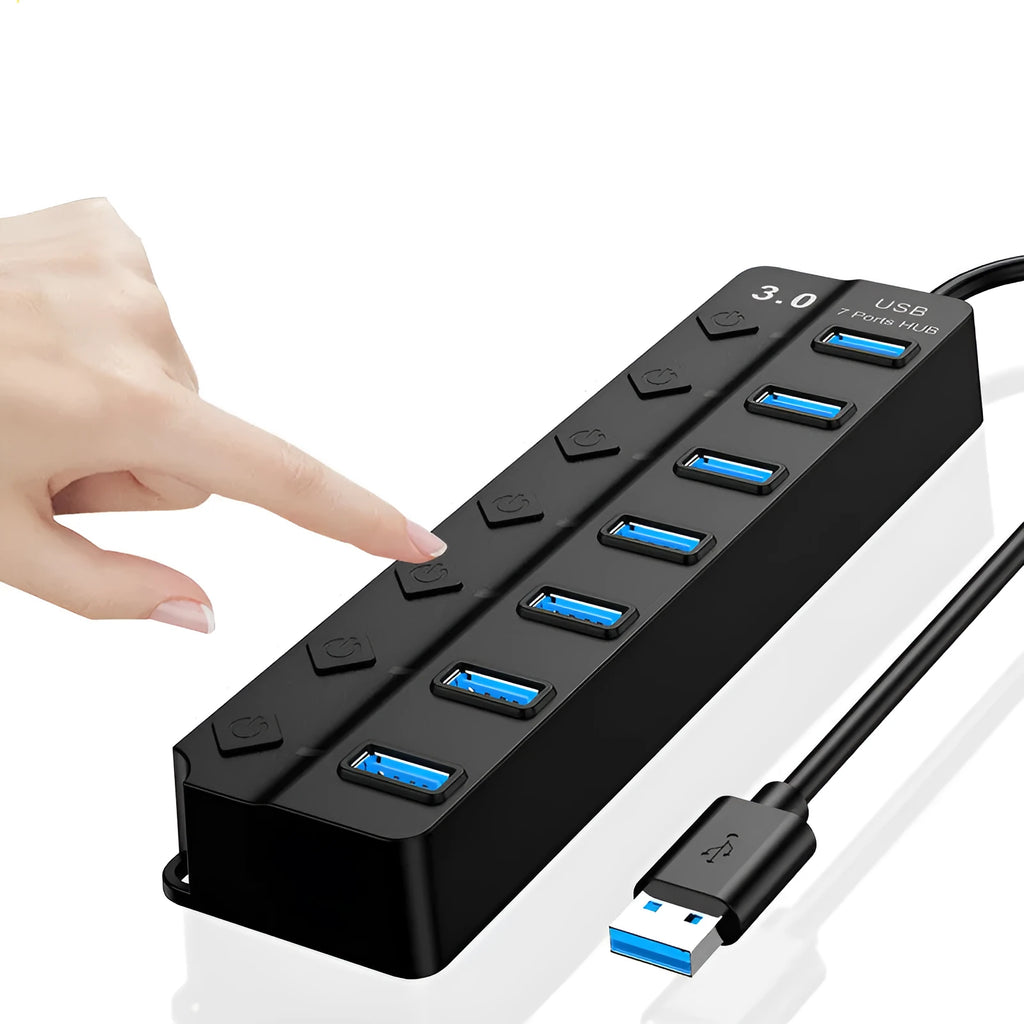 Black 7-port USB 3.0 hub with individual power switches and external power adapter on a wooden desk.