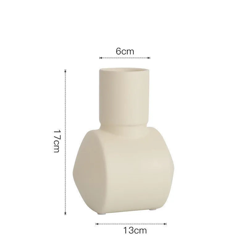 Hand-thrown white ceramic hammer vase in Morandi beige colour on a wooden table.