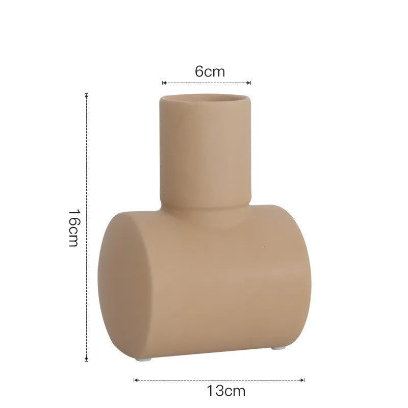 Hand-thrown white ceramic hammer vase in Morandi beige colour on a wooden table.