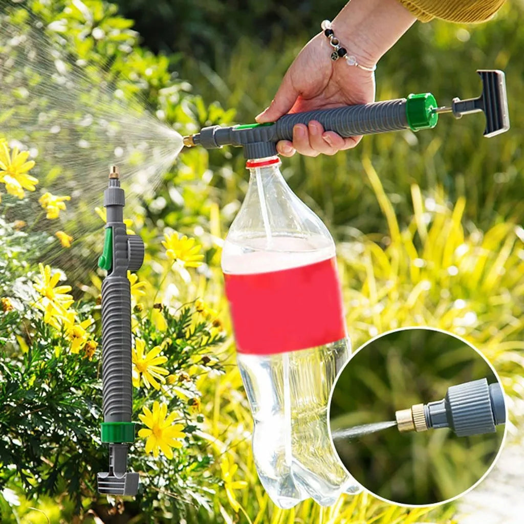 Plastic watering sprayer nozzle with extension tube attached to a large clear beverage bottle.