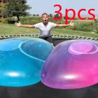 Assortment of inflated pink, yellow, blue and green TPR bouncy balls in different sizes on a plain background.