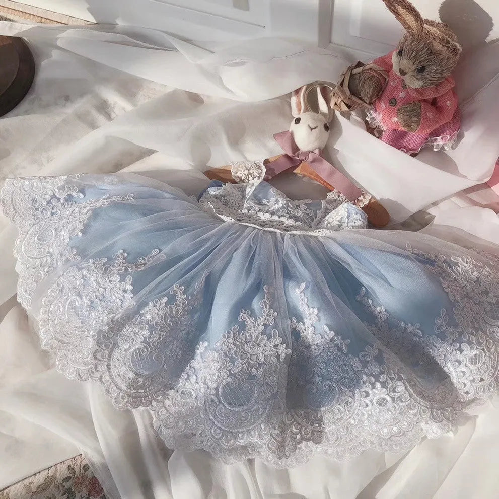 Ocean Blue baby girl princess dress with lace detailing on a hanger