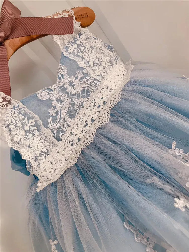 Ocean Blue baby girl princess dress with lace detailing on a hanger
