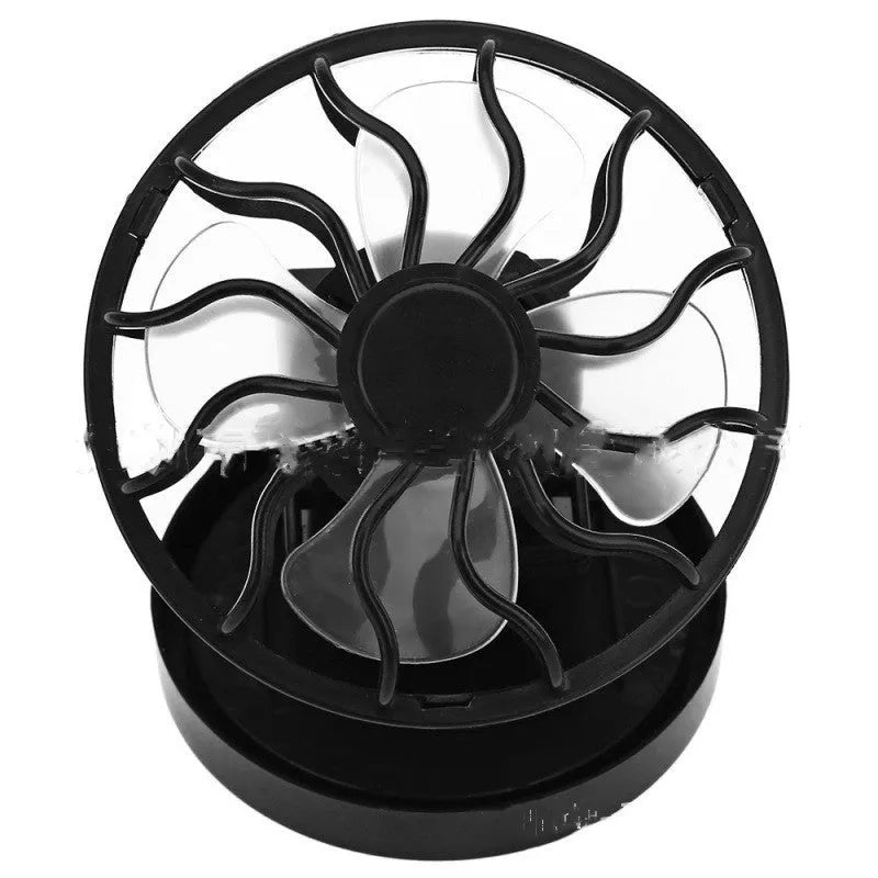 Black portable solar fan panel with clip, shown in an outdoor setting.