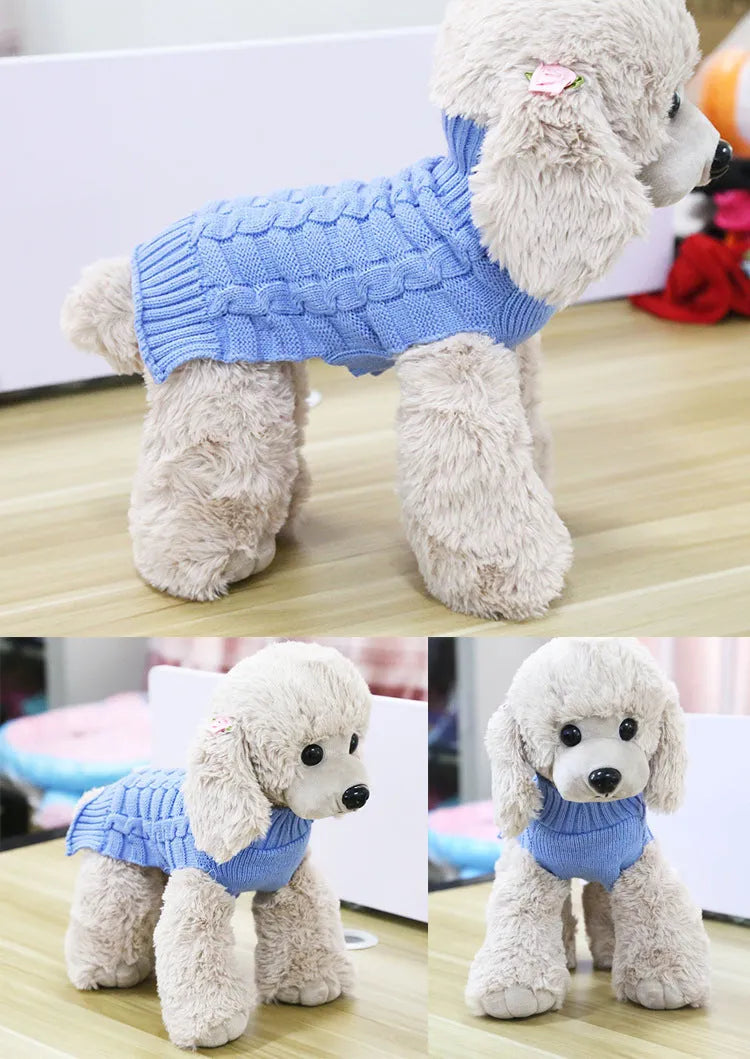 A blue cashmere wool dog sweater with a twisted rope design laid flat, showing its size and shape.