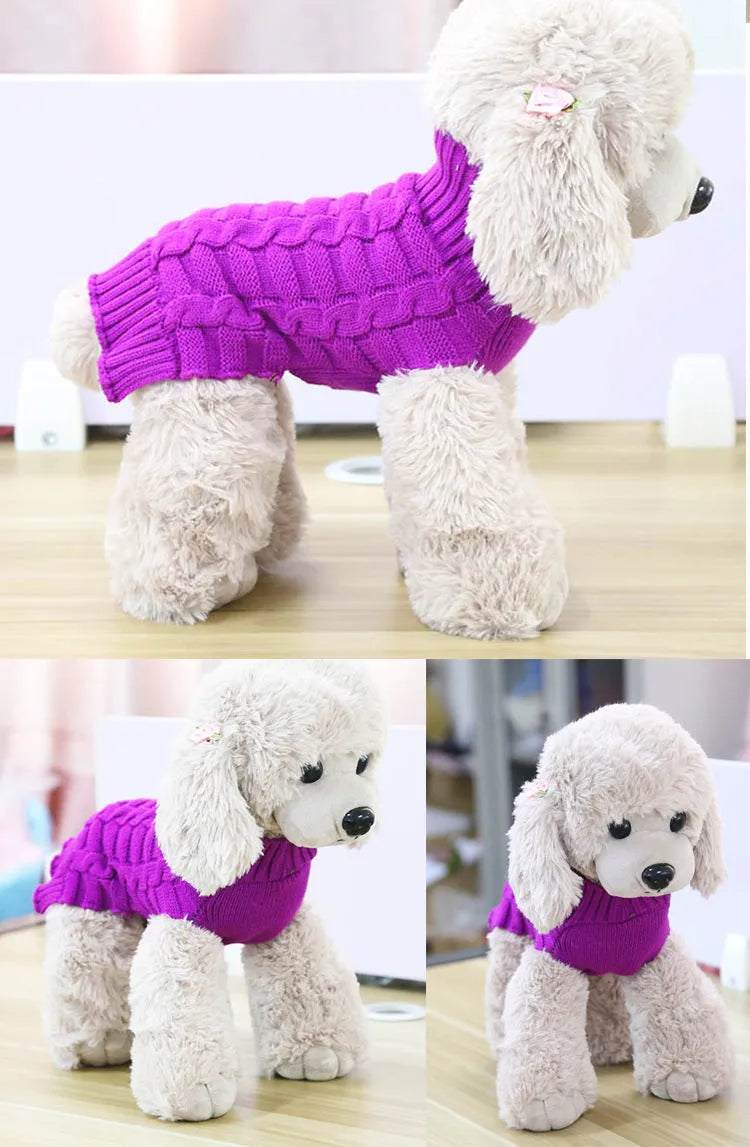 A blue cashmere wool dog sweater with a twisted rope design laid flat, showing its size and shape.