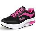 Women's grey powder heelless sports shoes with a middle heel on a plain background