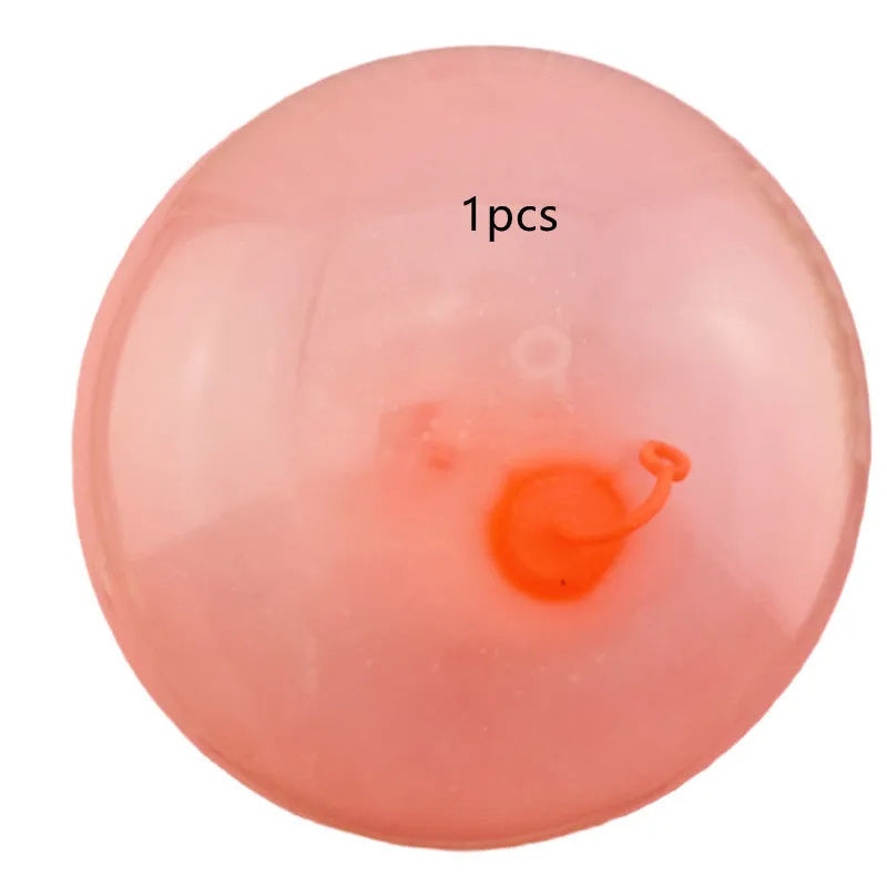 Assortment of inflated pink, yellow, blue and green TPR bouncy balls in different sizes on a plain background.