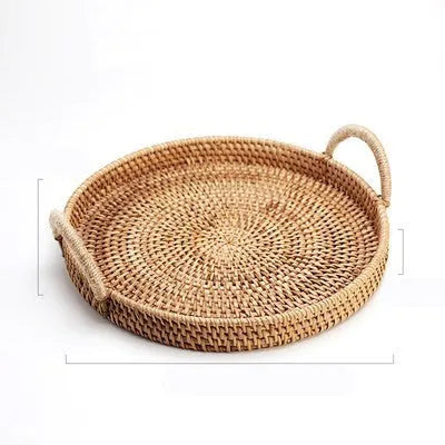 Round handwoven rattan storage basket with a light wooden handle on a table.