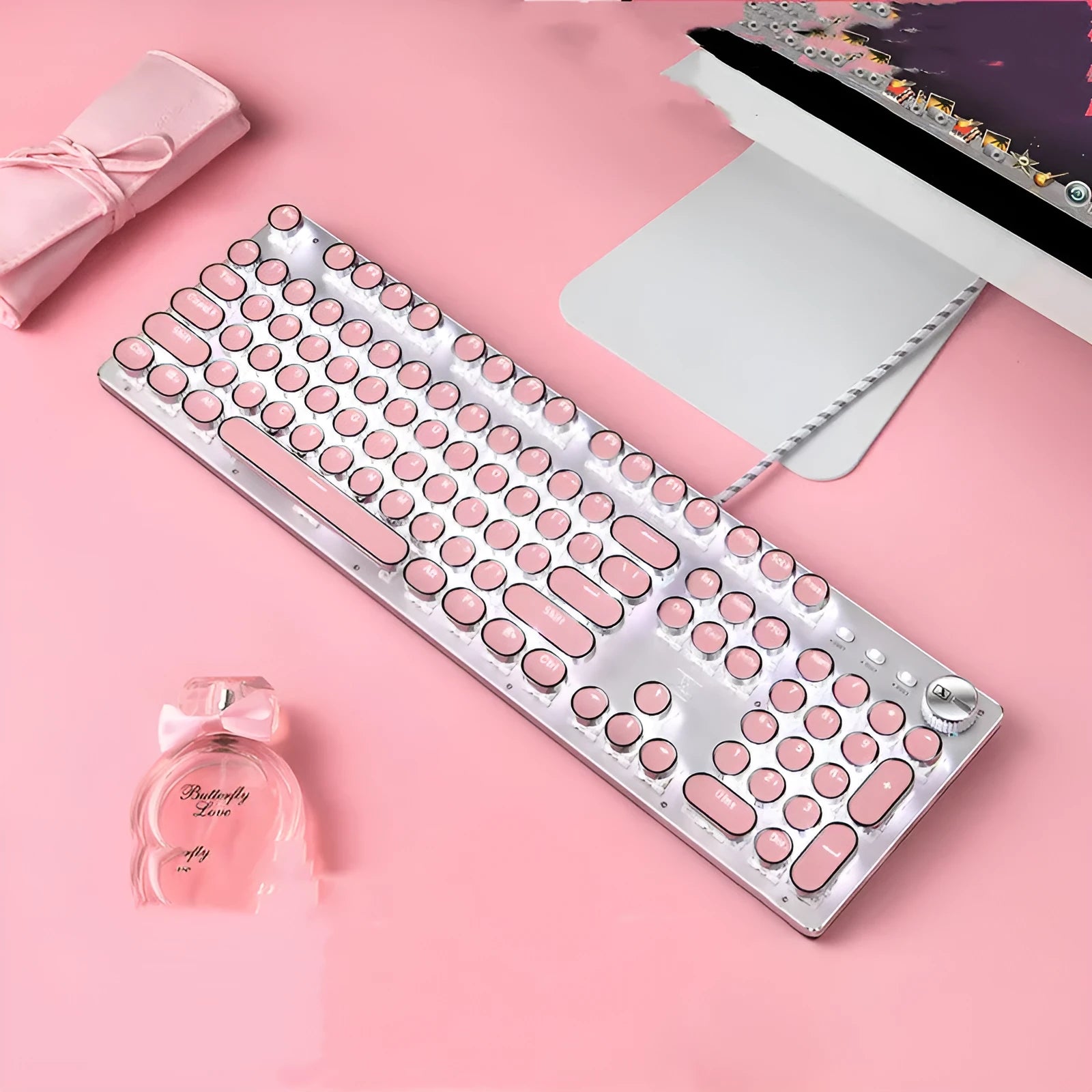Queen Lipstick mechanical keyboard with green switches, white backlight, silver and pink casing on a desk.