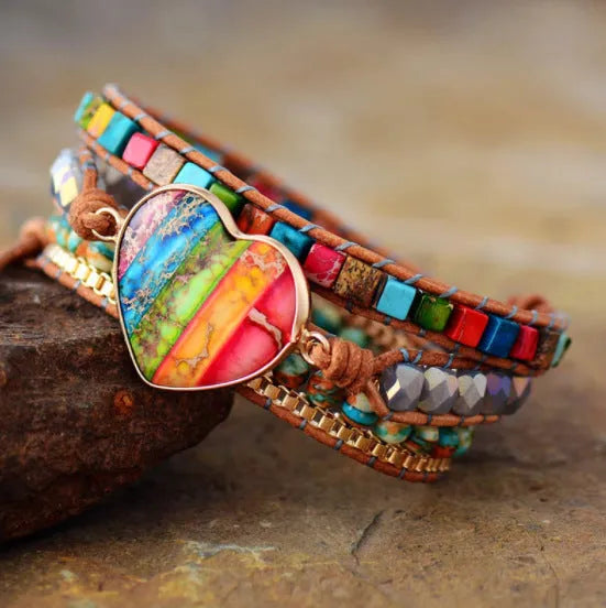 7 chakra leather wrapped bracelet with royal jasper crystal and agate beads on a flat surface