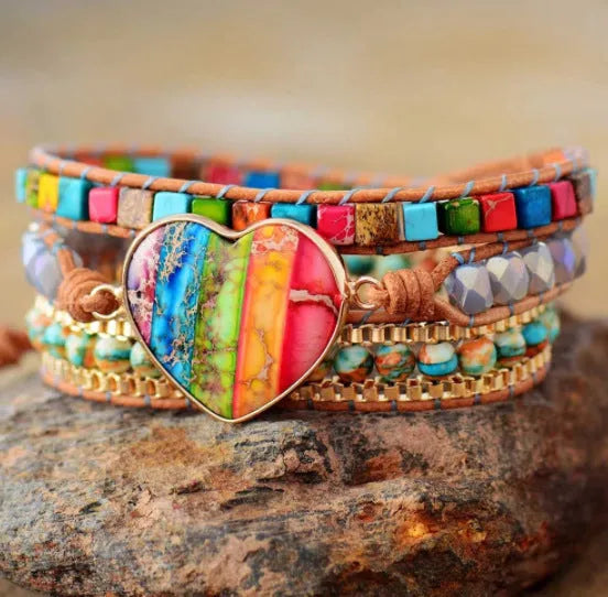 7 chakra leather wrapped bracelet with royal jasper crystal and agate beads on a flat surface