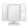 Trifold makeup mirror with 68 LED lights, 10X detachable magnifying mirror, and 180-degree rotation on a table