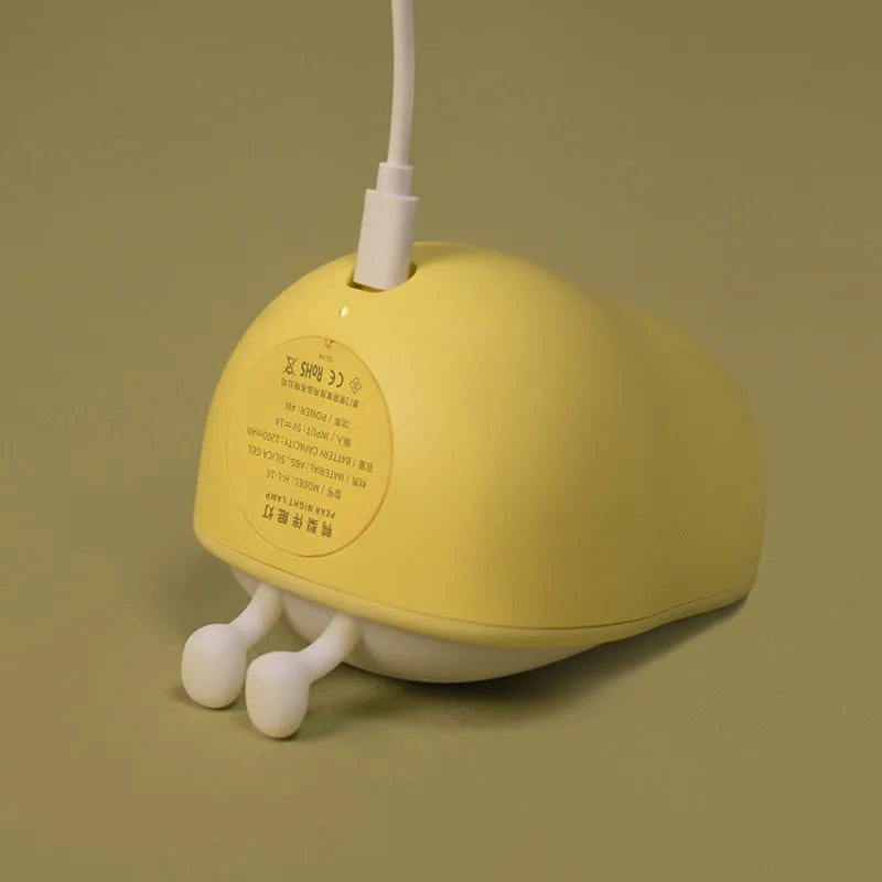 Warm yellow silicone PEAR night lamp with USB charging port and ABS base