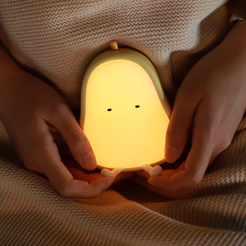 Warm yellow silicone PEAR night lamp with USB charging port and ABS base