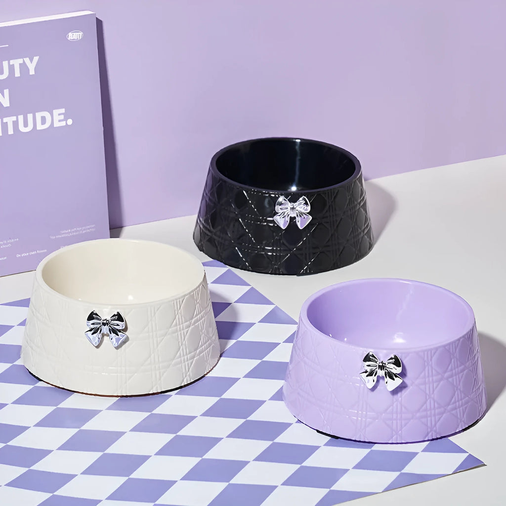 Diamond pattern pet feeding bowl with a bowknot decoration in black, purple or white with a pink or silver bow.