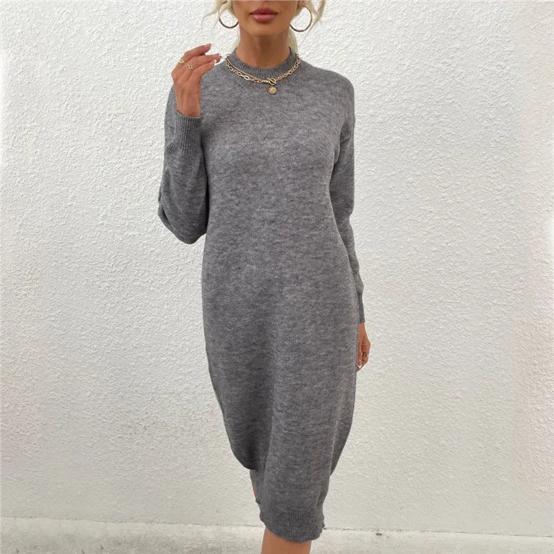Grey women's crew neck casual long sleeve acrylic sweater on a hanger.