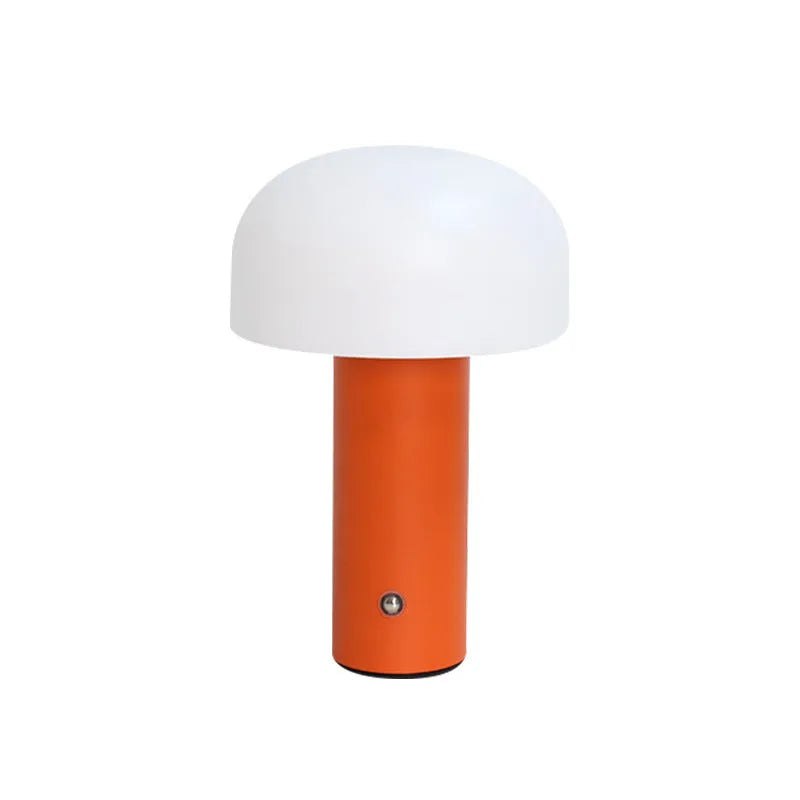 White plastic USB table lamp with integrated charging port on a wooden desk.