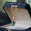 A gold-coloured geometric pendant on a copper chain necklace.