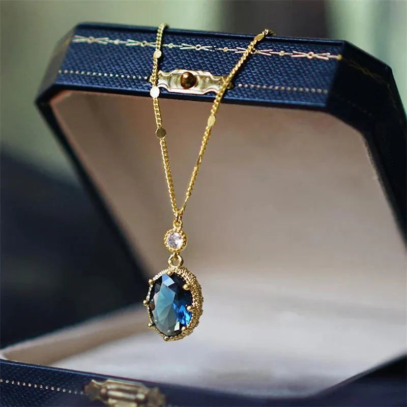 A gold-coloured geometric pendant on a copper chain necklace.