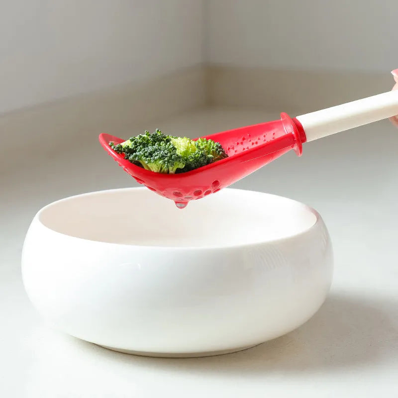 Red plastic multifunctional slotted spoon with half-enclosed head and convex serrations for cooking tasks