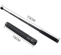 Black retractable aluminium selfie stick extended in hand next to a smartphone.