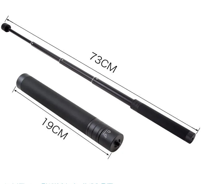 Black retractable aluminium selfie stick extended in hand next to a smartphone.