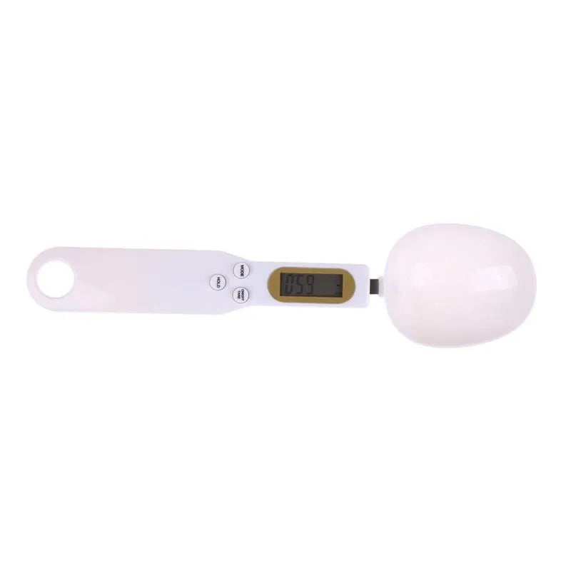 White digital spoon kitchen scale with LCD screen showing weight measurement.