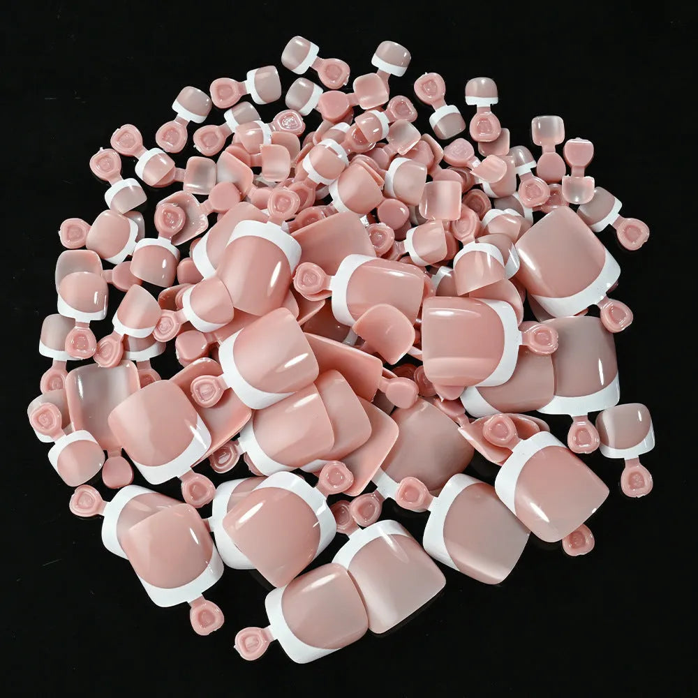 120 piece boxed set of full square short artificial toenails with French white edge design on nude base