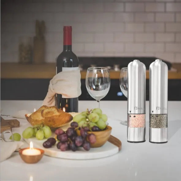 Electric stainless steel pepper grinder with natural colour finish on a kitchen counter