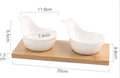 Porcelain ceramic dried fruit dish with wooden board, showing multiple grid compartments for snack separation.
