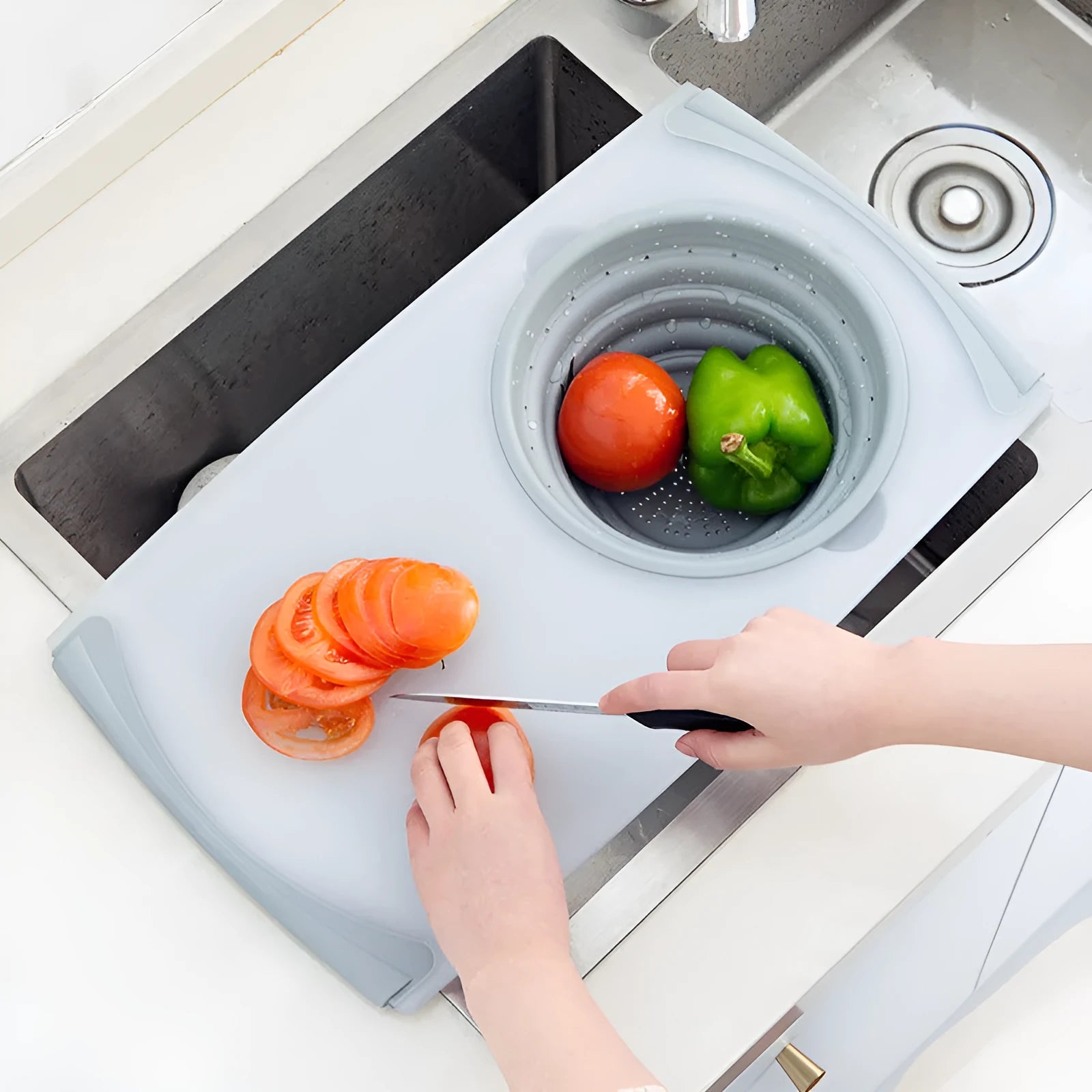 Grey folding chopping board with detachable drain basket showing 50cm cutting surface