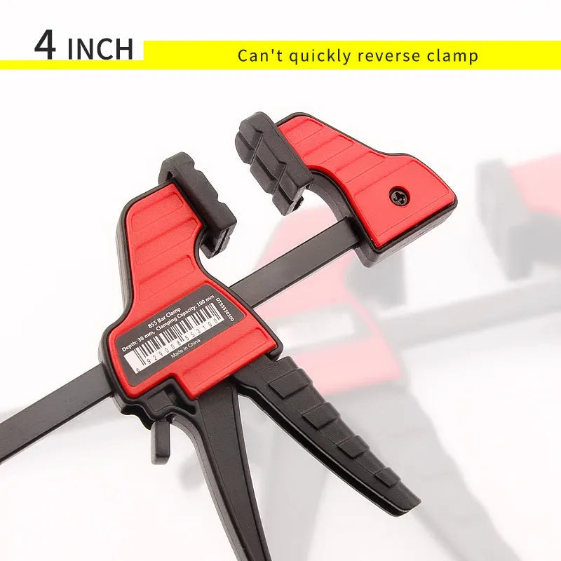 Black plastic woodworking clamp with quick-release trigger and soft rubber protective jaws.