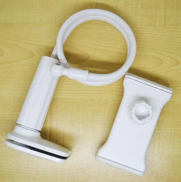 Black bedside phone handset with long adjustable arm and clamp base on a wooden table.