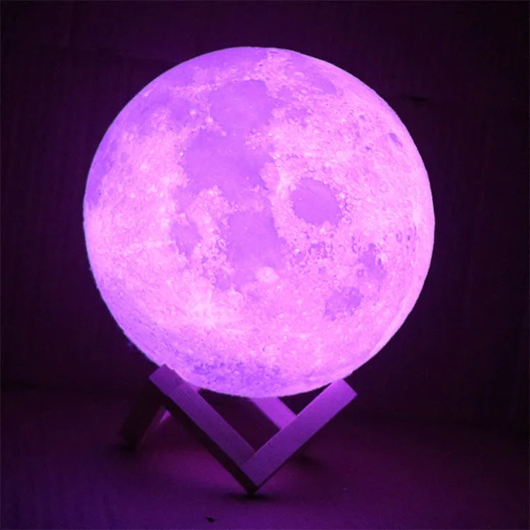3D printed moon lamp on wooden stand showing detailed lunar surface, with touch ring at base.